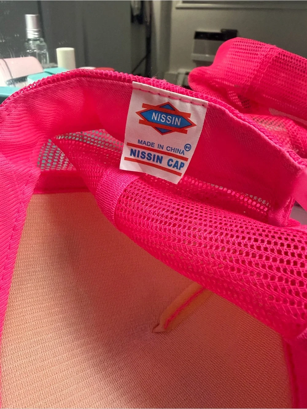 Hot pink trucker hat with “Chloe” in spray paint